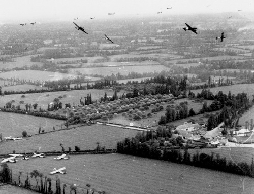 Douglas C-47 aircraft bank for England after their CG-4A gliders have cut loose from their tow lines